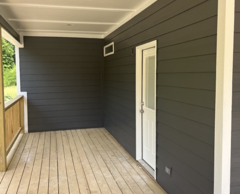 a porch with a white door