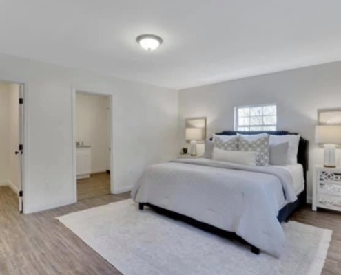 a bedroom with a bed and a rug