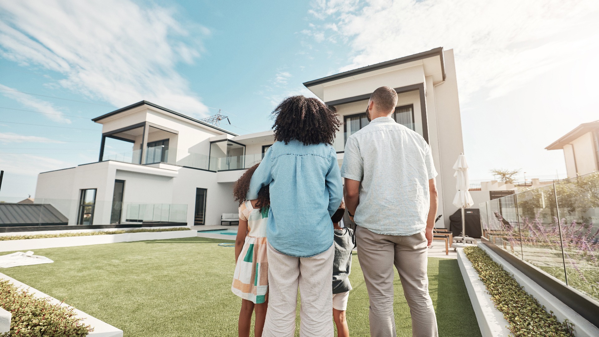 a group of people standing in front of a house